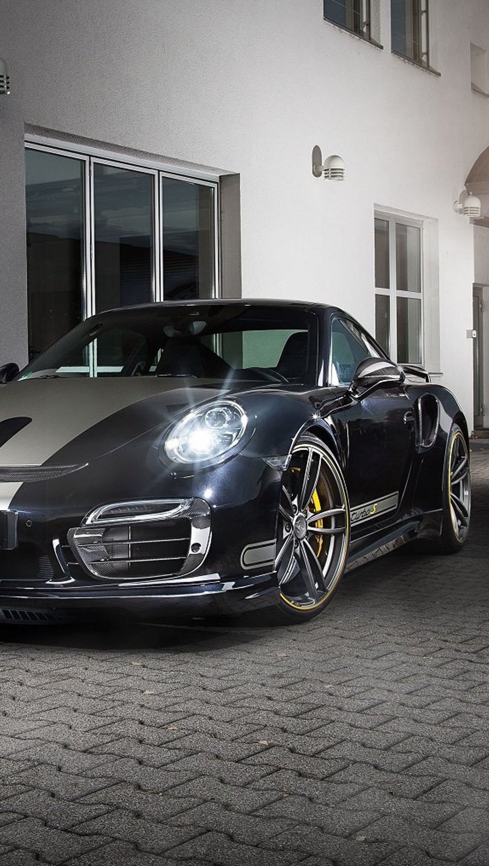 Arafed black sports car parked in front of a building (911, car, design, porsche)