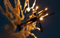 Helicóptero Apache lançando flares no céu noturno