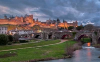 Vista nocturna de un castillo histórico con vistas a una aldea serena