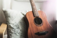 Warm Acoustic Guitar on a Cozy Chair