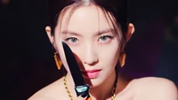 Irene from Red Velvet showcasing intense charisma with a knife, embodying the concept of "Monster" in a captivating MV scene.