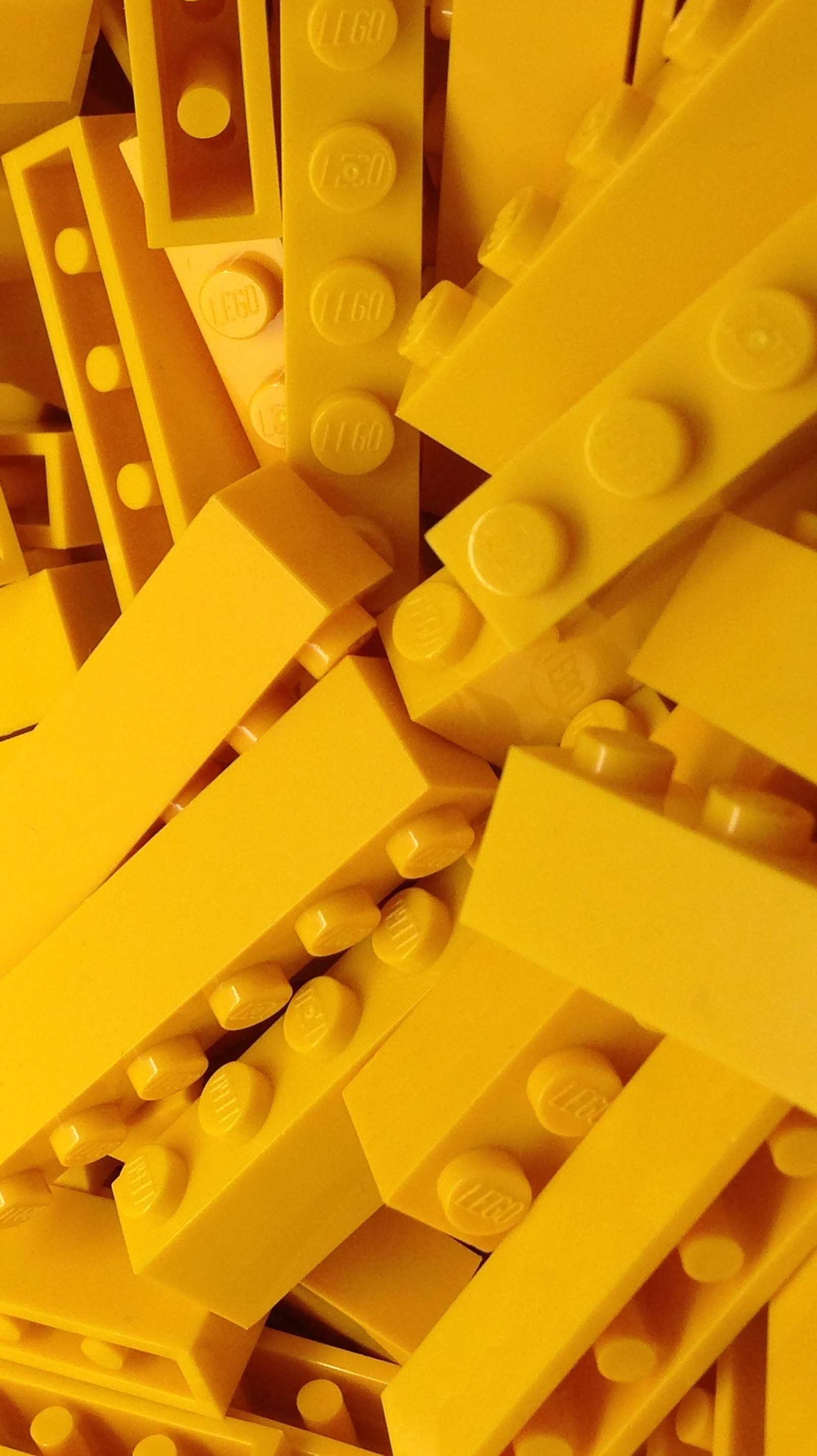 A close up of a pile of yellow lego bricks with one missing (lego, yellow)