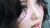 Joy from Red Velvet showcasing ethereal beauty with captivating eyes and soft, wavy hair, embodying the essence of K-pop glamour.