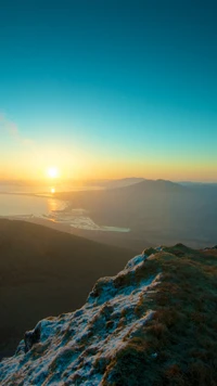 Sonnenuntergang über dem ruhigen See und majestätischen Bergen