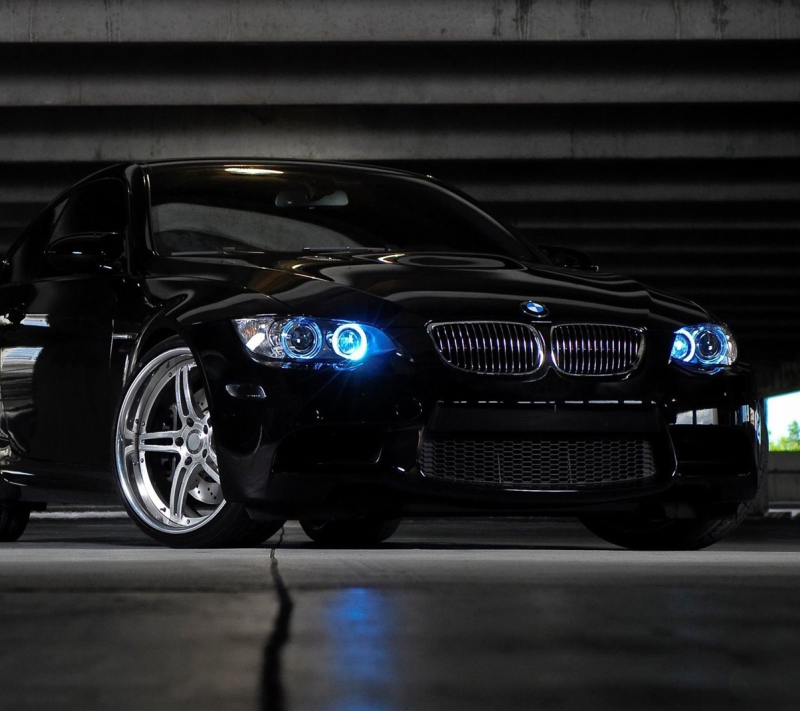 A close up of a black car parked in a parking garage (330, 330i, angel, auto, black)