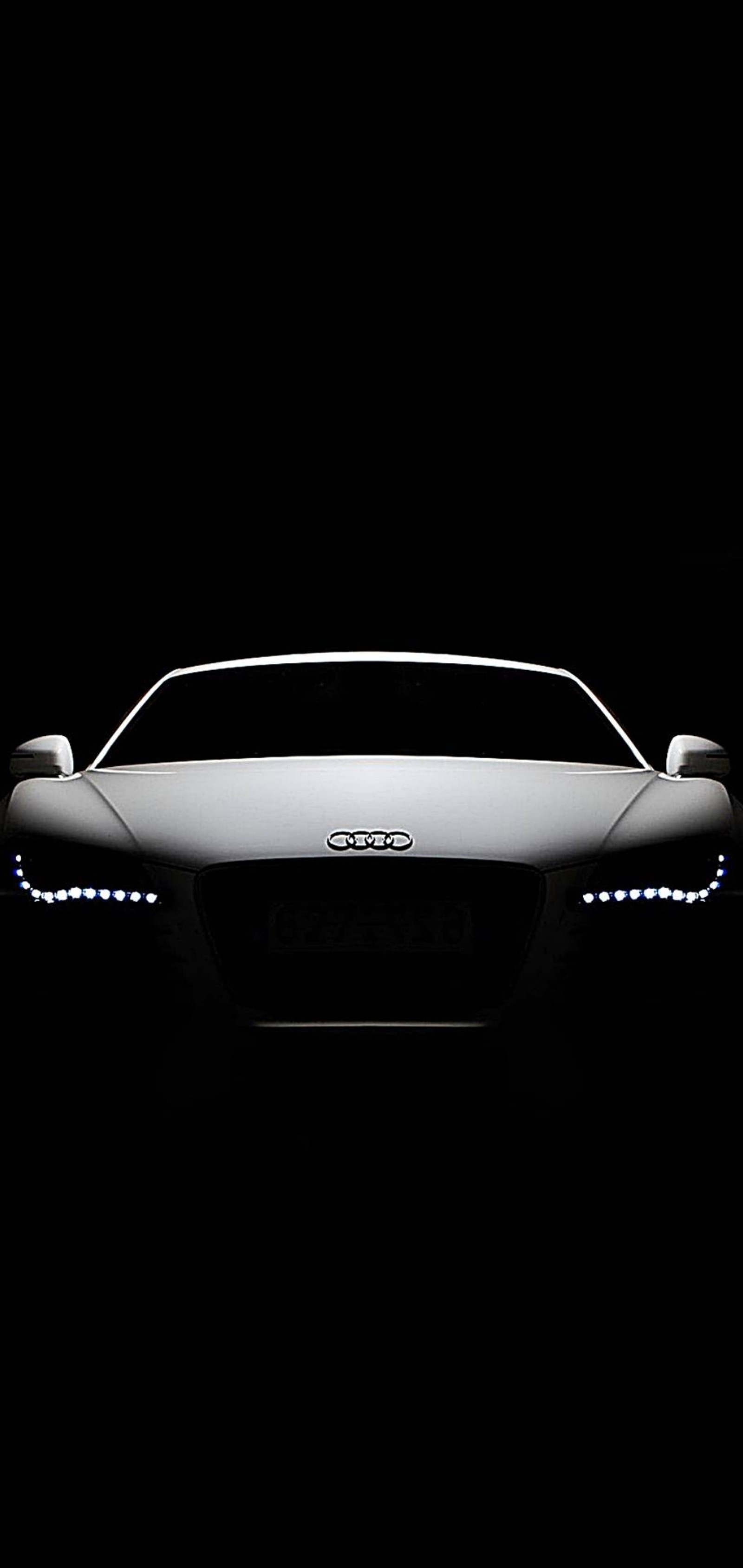 A close up of a car in the dark with a light on (car, voiture, audi, black, neon)