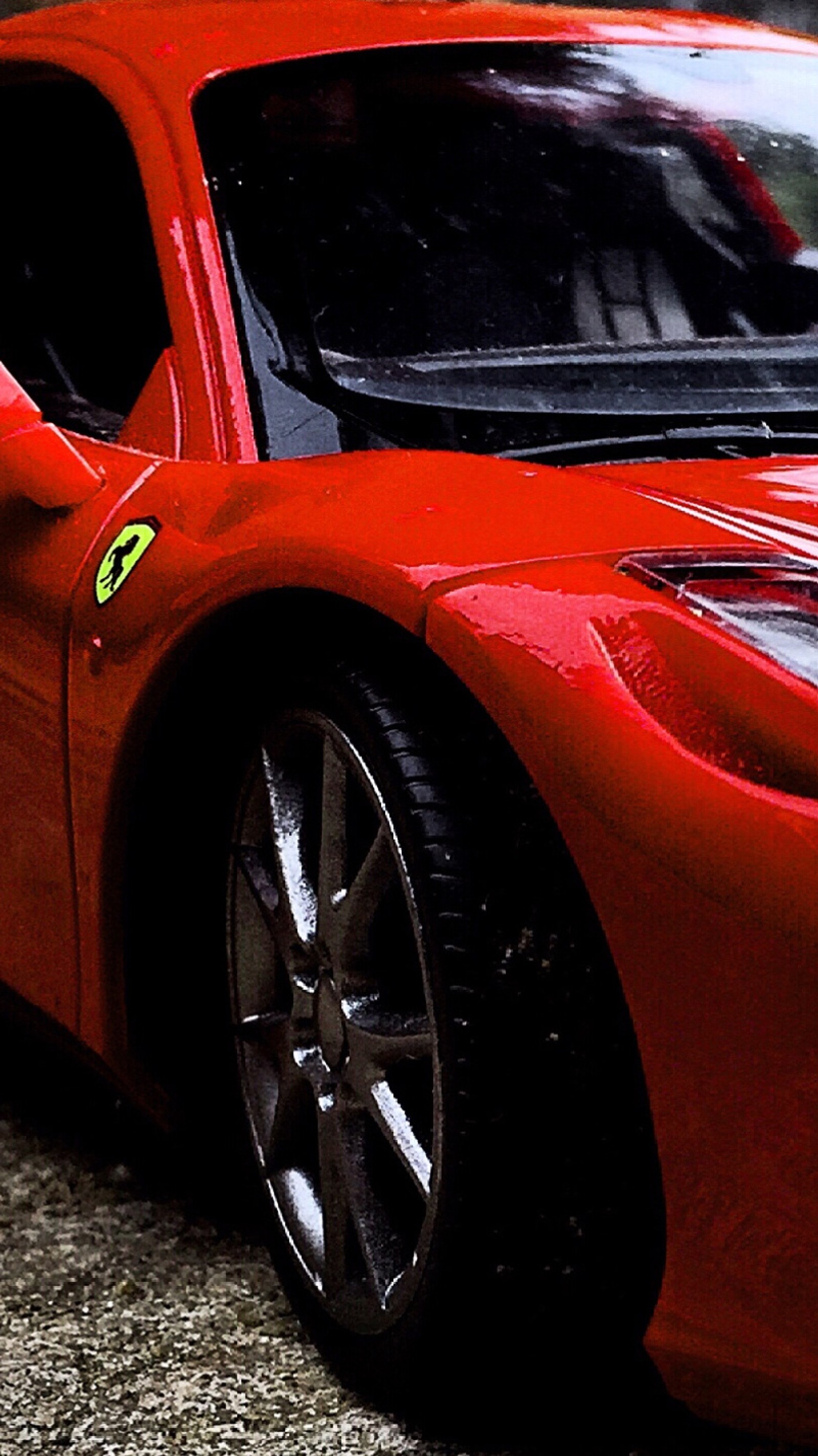 A close up of a red sports car parked on a street (car, expensive, ferarri, life, red)