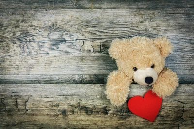 Plush Teddy Bear Holding a Heart on Rustic Wood Background