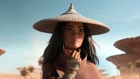 Raya, the determined warrior from "Raya and the Last Dragon," stands confidently in a desert landscape, wearing her signature conical hat and traditional attire.