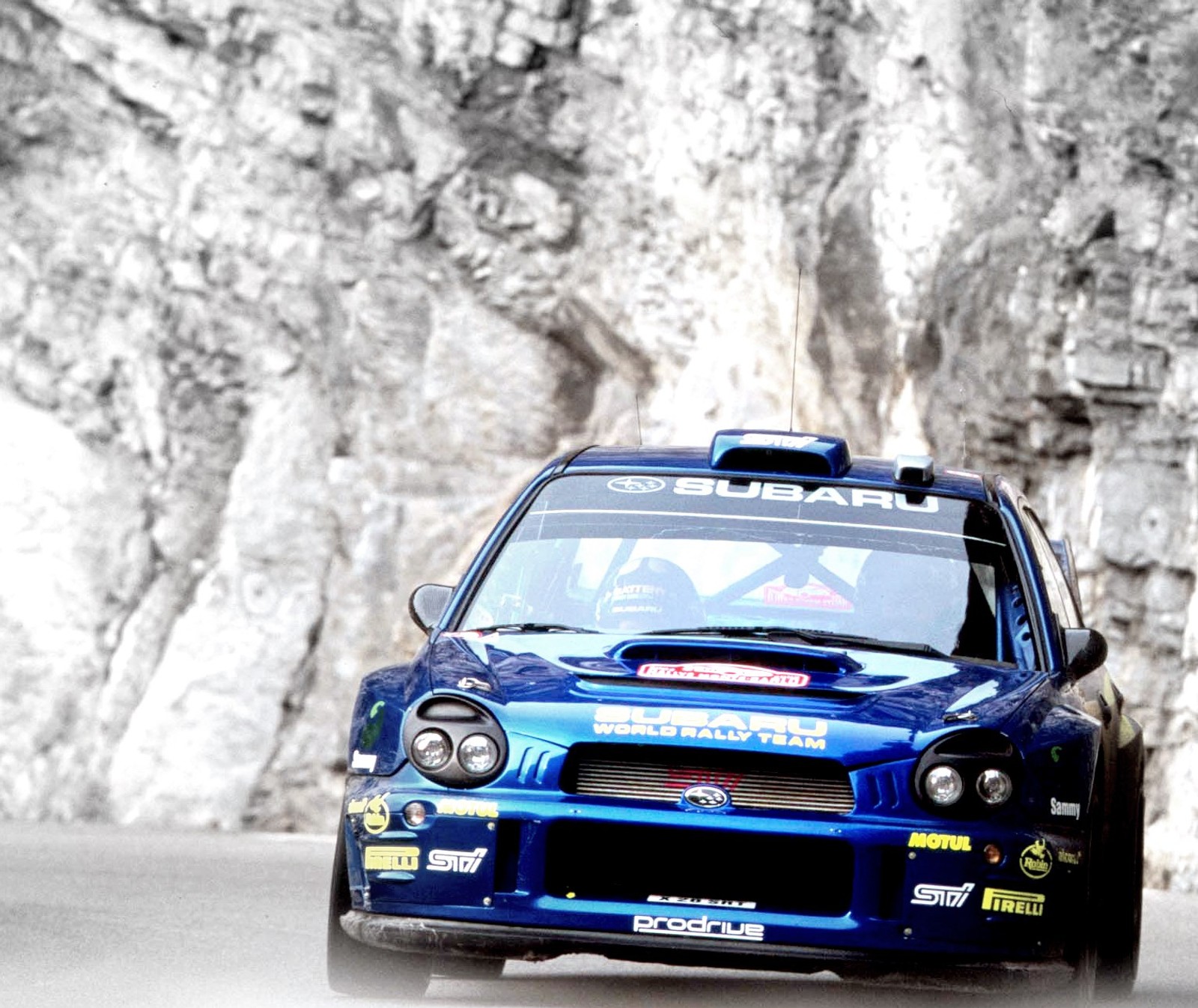 Arafed car driving on a road with a mountain in the background (car, fast, impreza, race, rally)