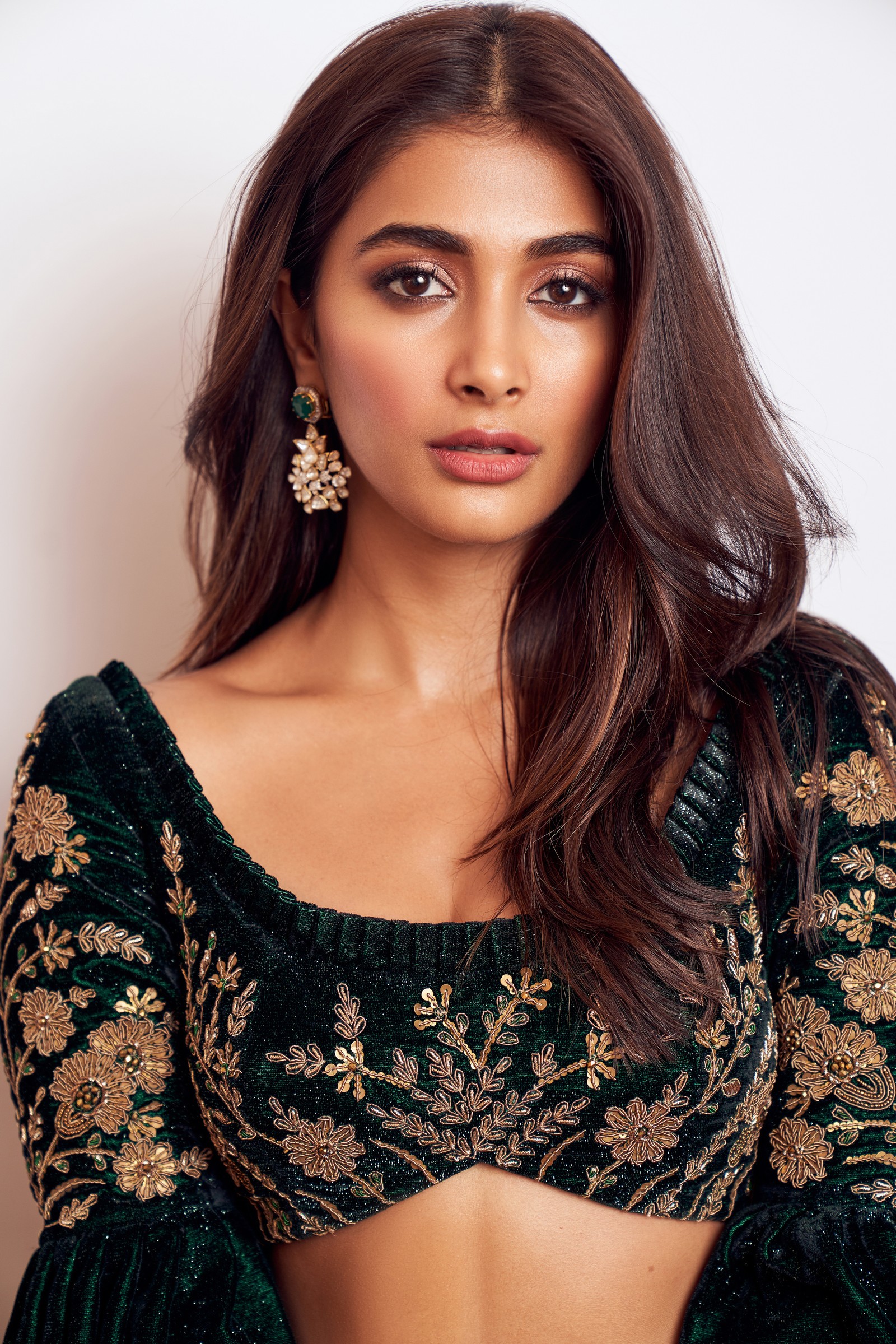 A close up of a woman wearing a green blouse and gold earrings (pooja hegde, indian actress, bollywood actress, portrait, maxim)