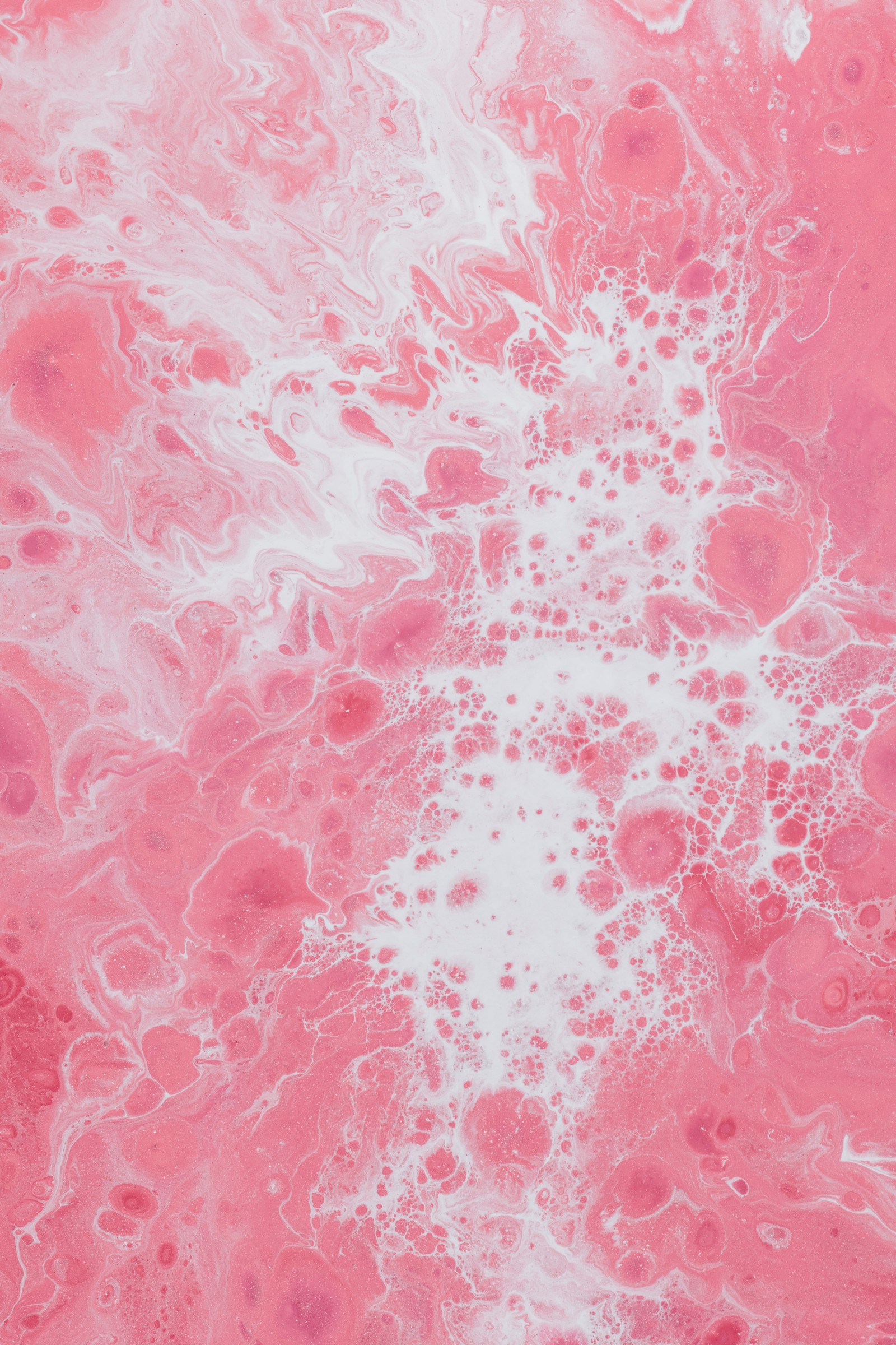 A close up of a pink and white marbled surface with a lot of bubbles (pink, red, pattern, peach, design)