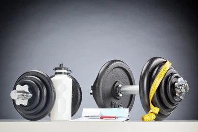 Dumbbells, Water Bottle, and Measuring Tape: Essentials for Strength Training and Fitness