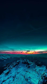 Montagnes majestueuses couvertes de neige sous un ciel de coucher de soleil vibrant