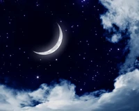 Celestial Night: A Crescent Moon Amidst Starry Clouds