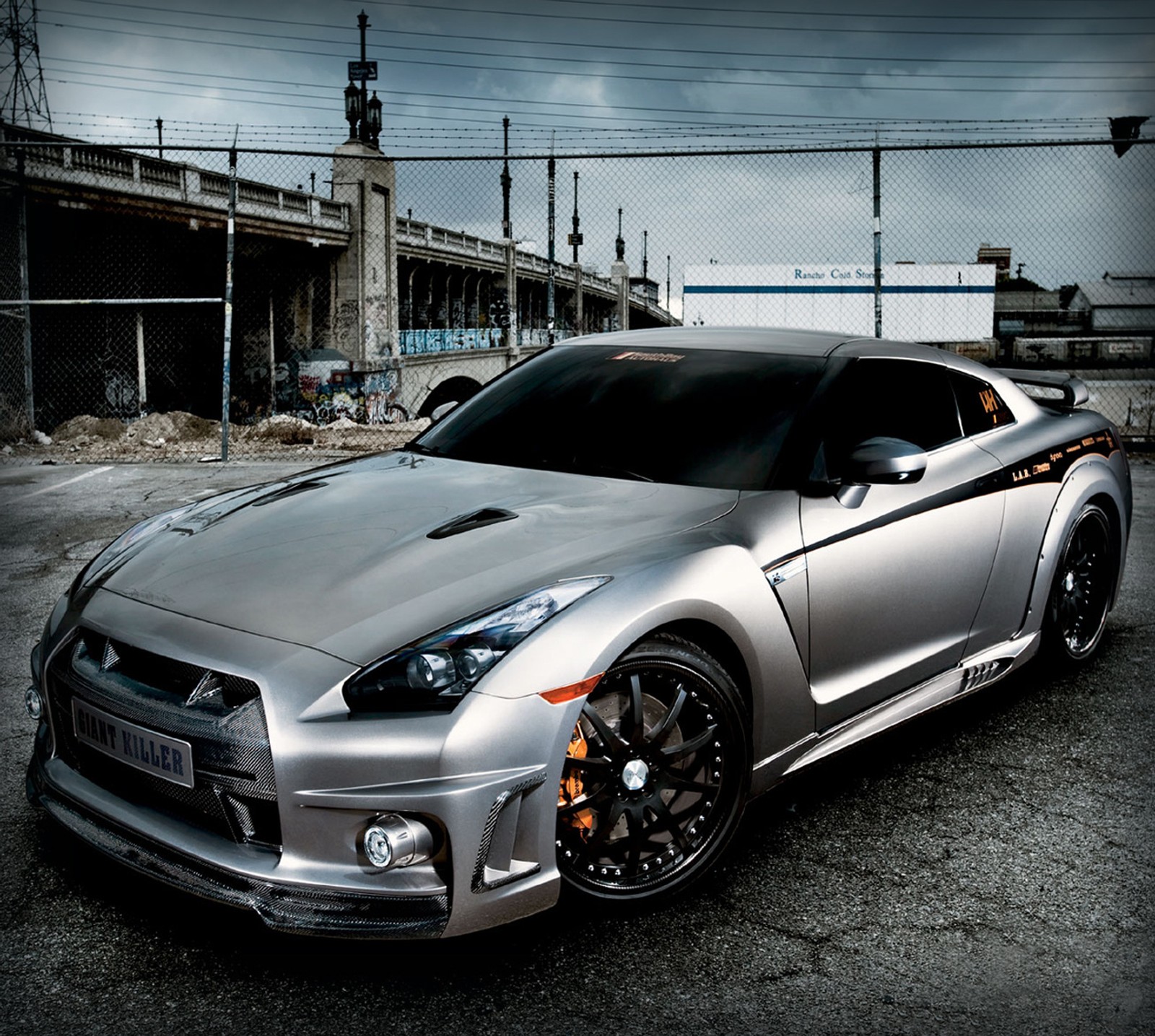 Arafed sports car parked in a parking lot with a cloudy sky (auto, nissan gtr)