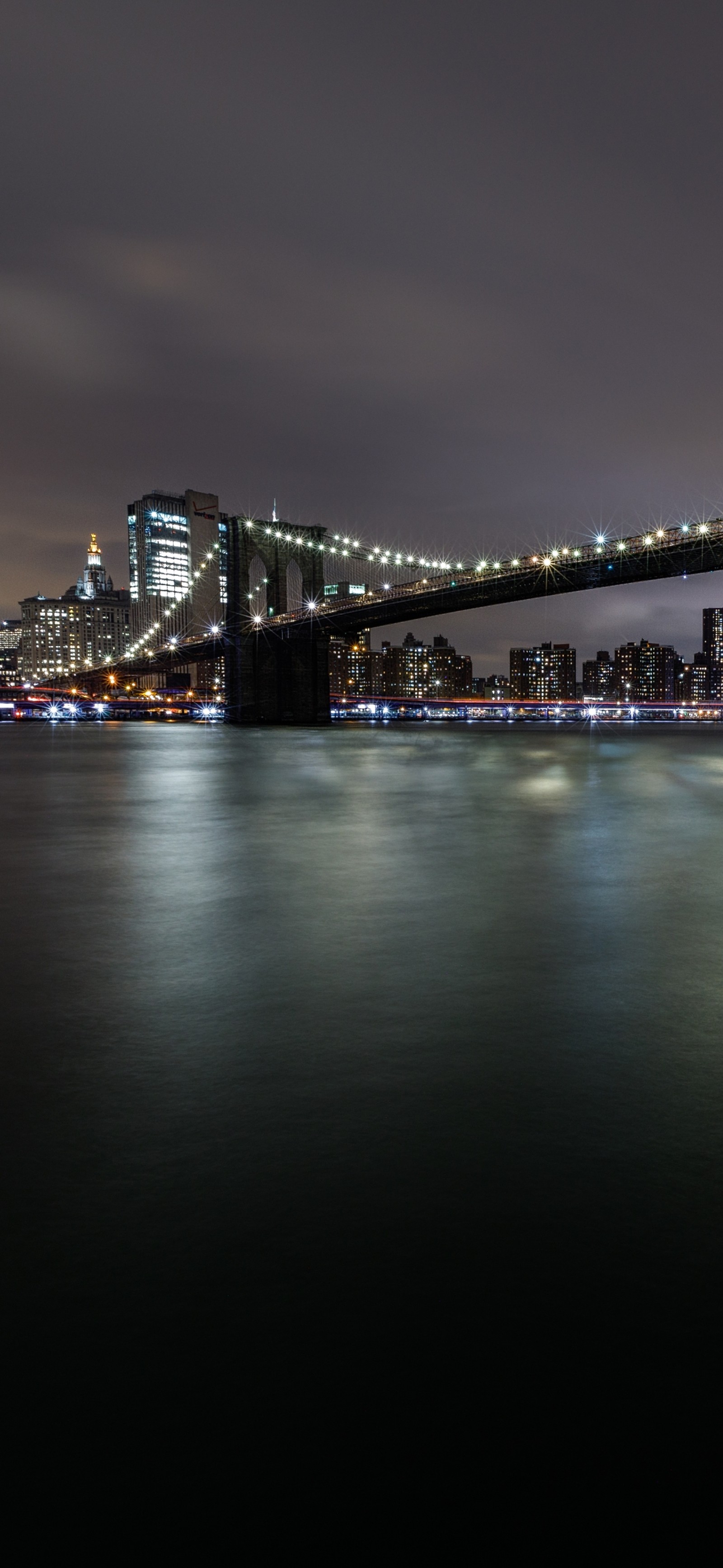 Arafed view of a bridge over a body of water at night (reflection, water, building, body of water, dusk)