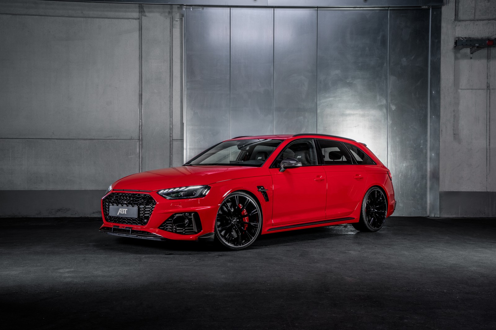 A red audi rs4 is parked in a garage (audi rs 4 avant, abt, 2021, dark background, red cars)