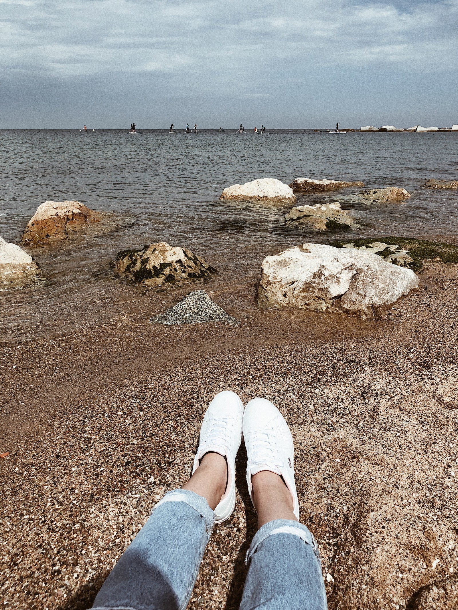 Someone is sitting on the beach with their feet up (sea, beach, tourism, water, human)