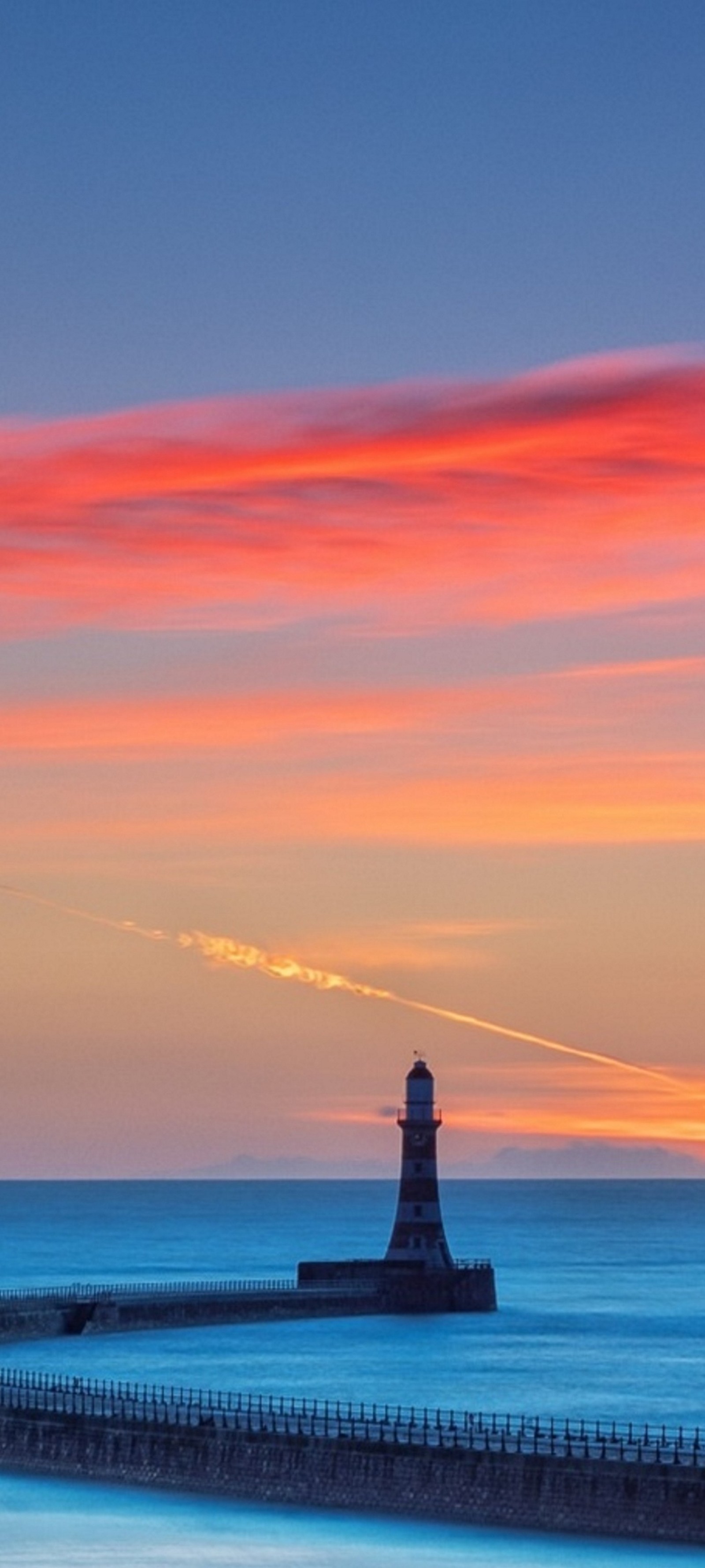 Arafed view of a lighthouse with a red sky in the background (cloud, water, lighthouse, atmosphere, afterglow)