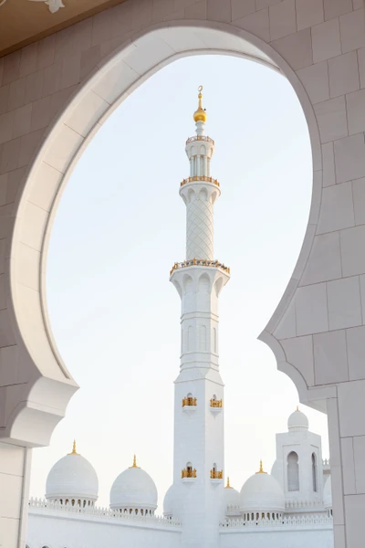 Majestic Mosque Minaret Framed by Ornate Arch