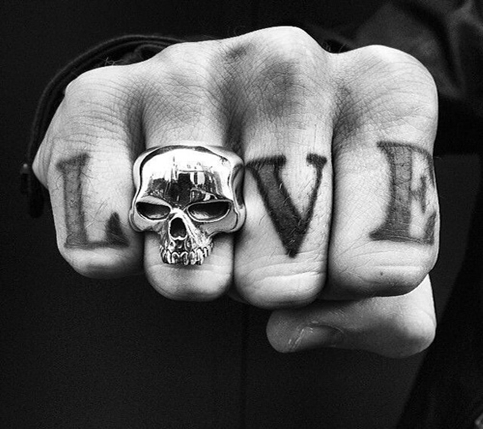 Arafed hand with a skull and love written on it (love, word)