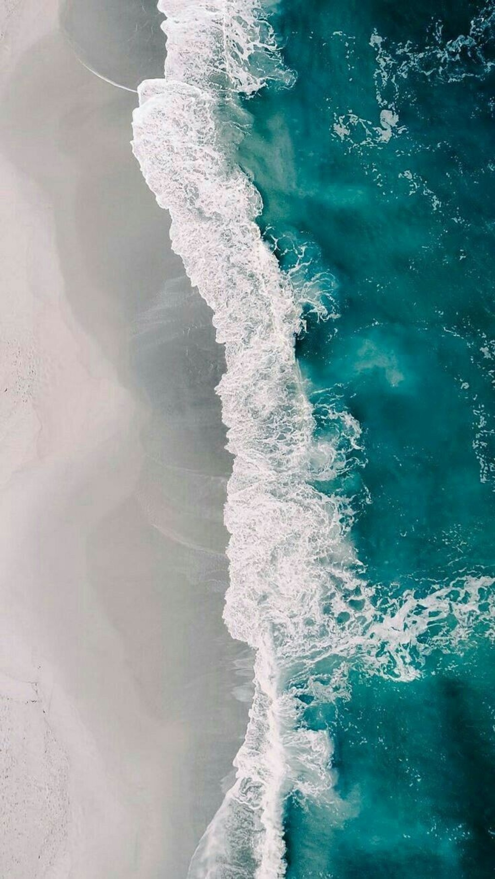 Aerial view of a beach with a white sand and blue water (ocean, water, blue, oceans, waves)