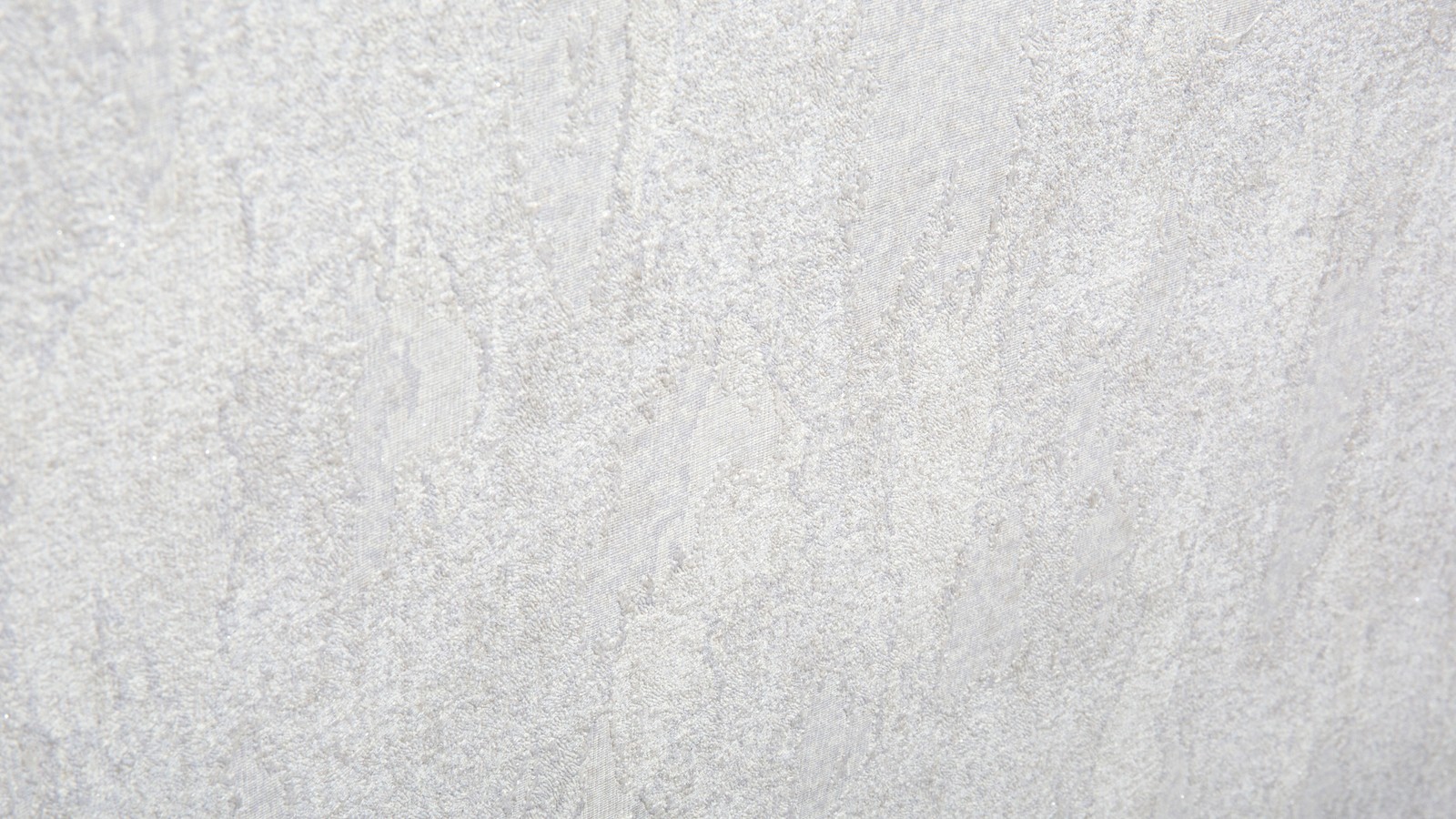 A close up of a white wall with a black and white clock (texture, paper, recycling)