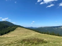 Expansive Highland Landscape with Rolling Hills and Mountainous Terrain