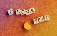 I Love You" in Yellow Hearts on Wooden Background