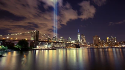 Nighttime Cityscape: Brooklyn Bridge and Skyscraper Reflections Under Illuminated Beams