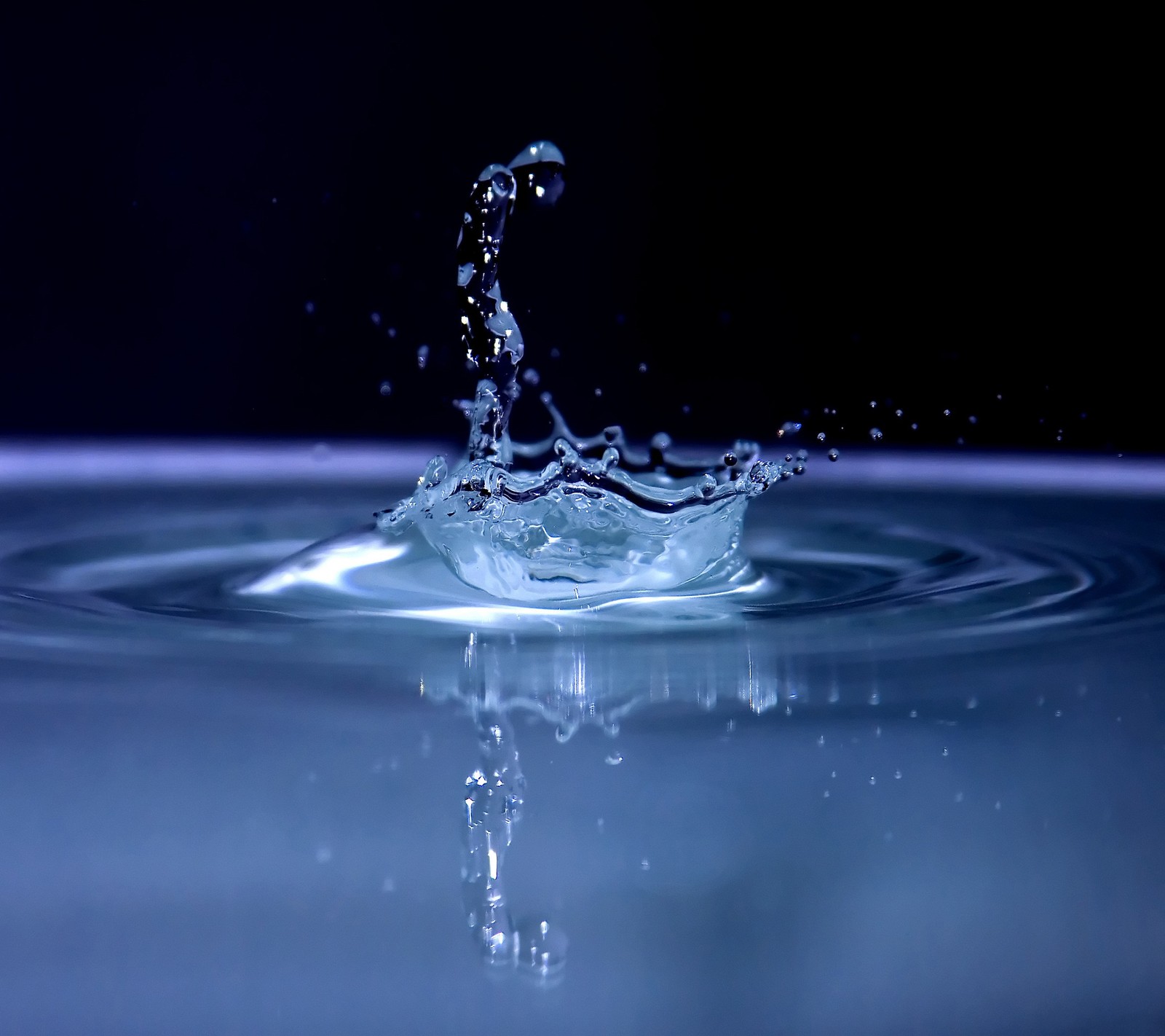 A close up of a water drop with a black background (2160x1920, wallpaper)