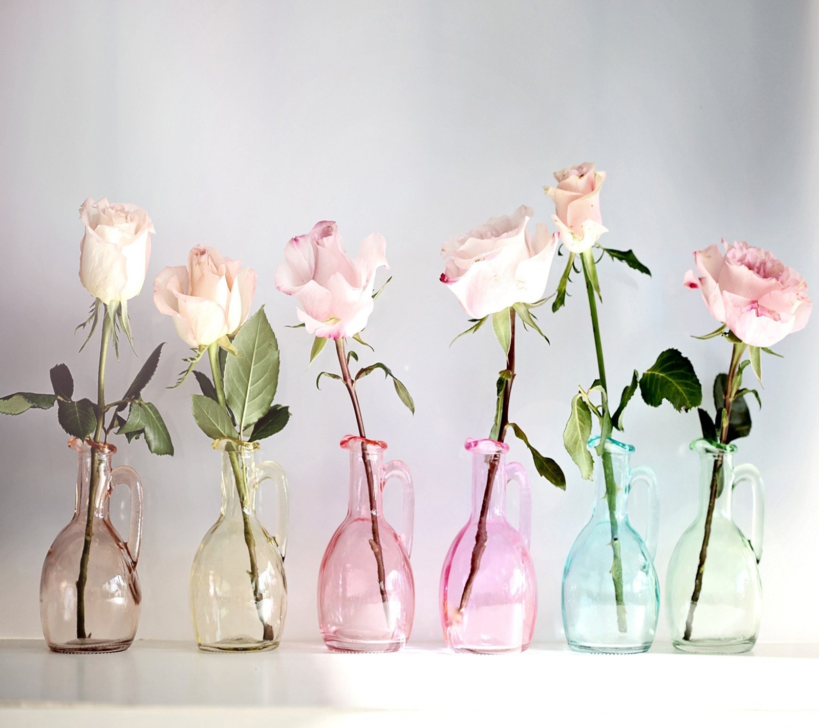 There are four vases with flowers in them on a table (beautiful, simply)