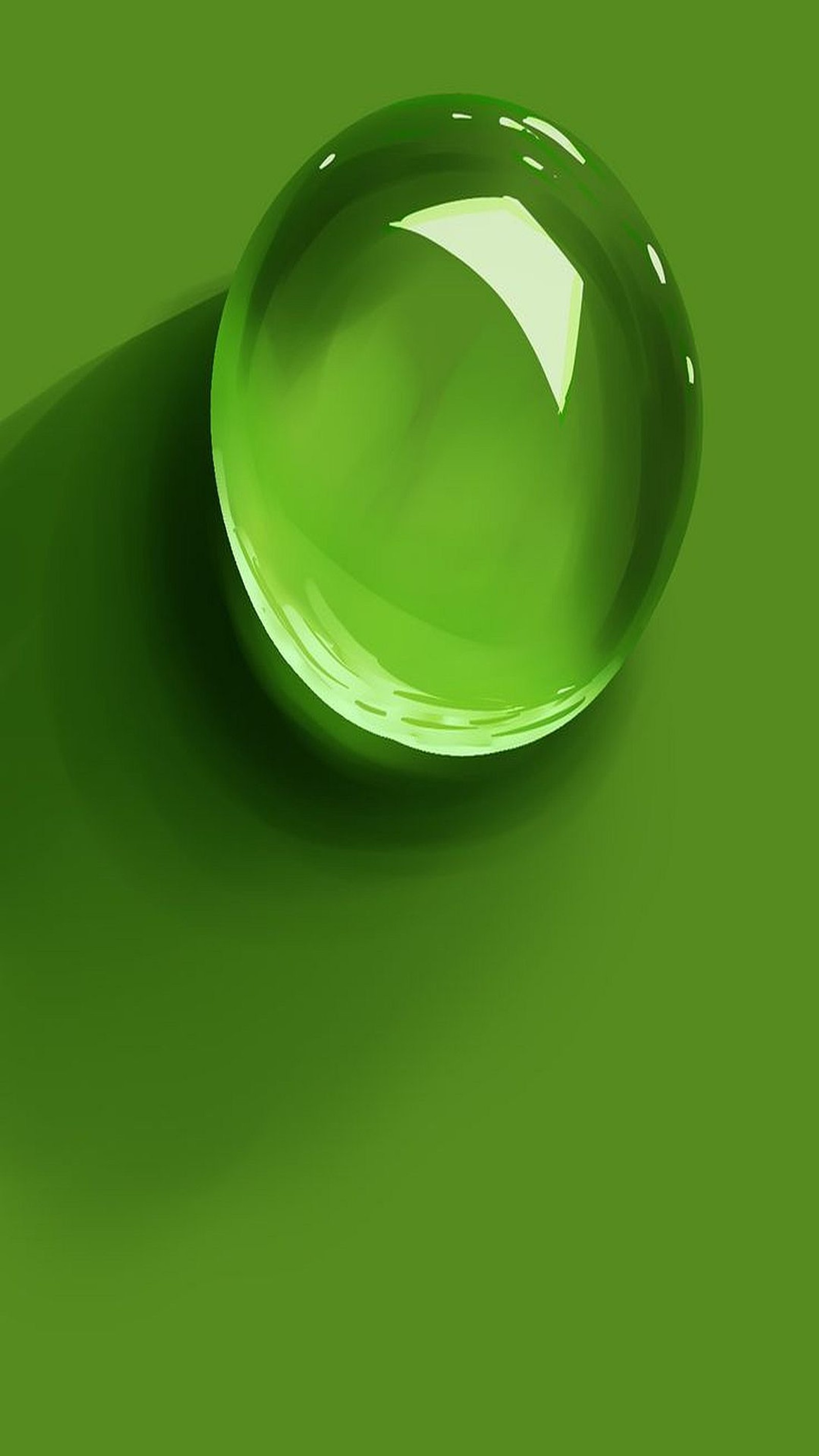 A close up of a green glass ball on a green surface (drop, green)