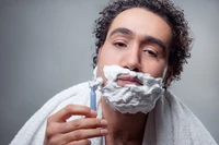 Man Shaving with Foam and Curly Hair