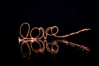 Light Painting of 'Love' Reflected in Darkness