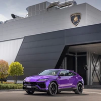 Lebendiger lila Lamborghini Urus vor einem modernen Gebäude