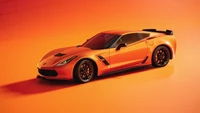 Atemberaubender orange Chevrolet Corvette vor einem lebhaften Hintergrund