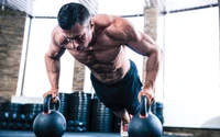 Intense kettlebell push-ups for muscle building and physical fitness.