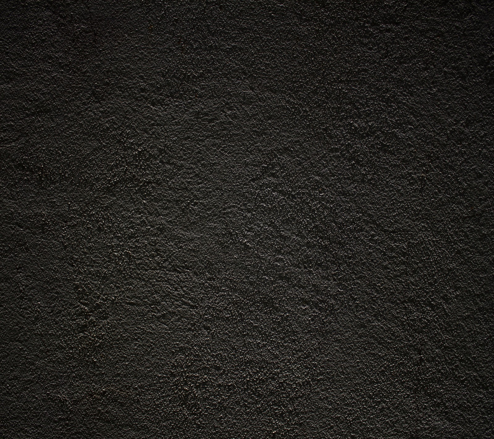 A close up of a black wall with a white clock on it (black, cement, dark, pattern, texture)