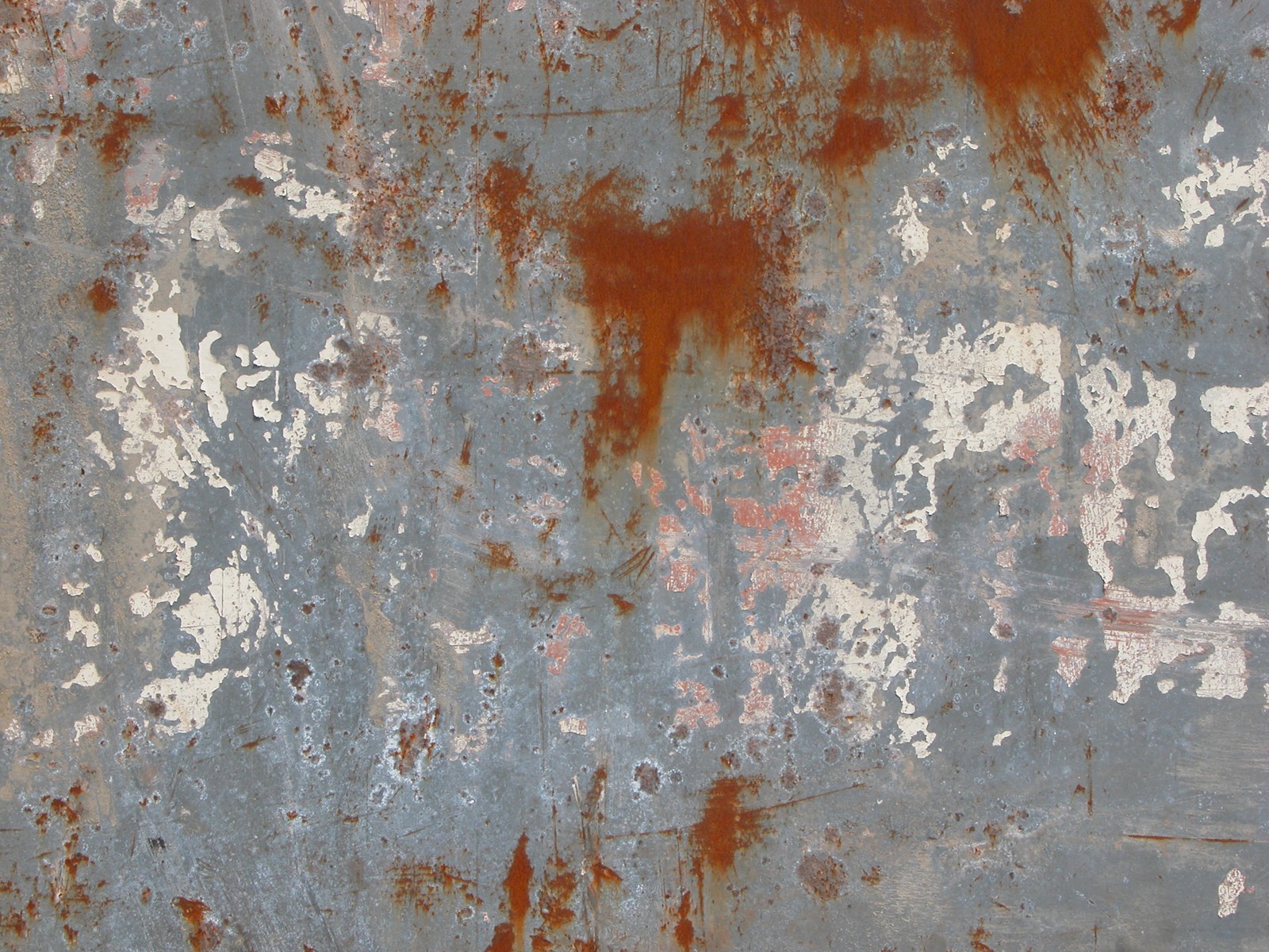 A close up of a rusted metal surface with a red and white paint (rust, metal, corrosion, iron, steel)