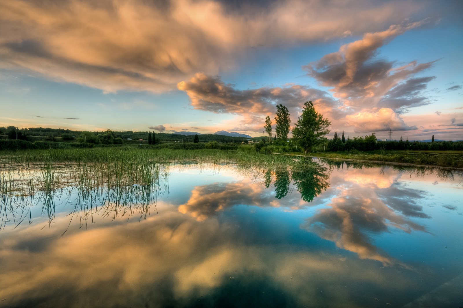 Una vista de un lago con un árbol y nubes reflejadas en él (naturaleza, lago, reflexión, paisaje natural, nube)