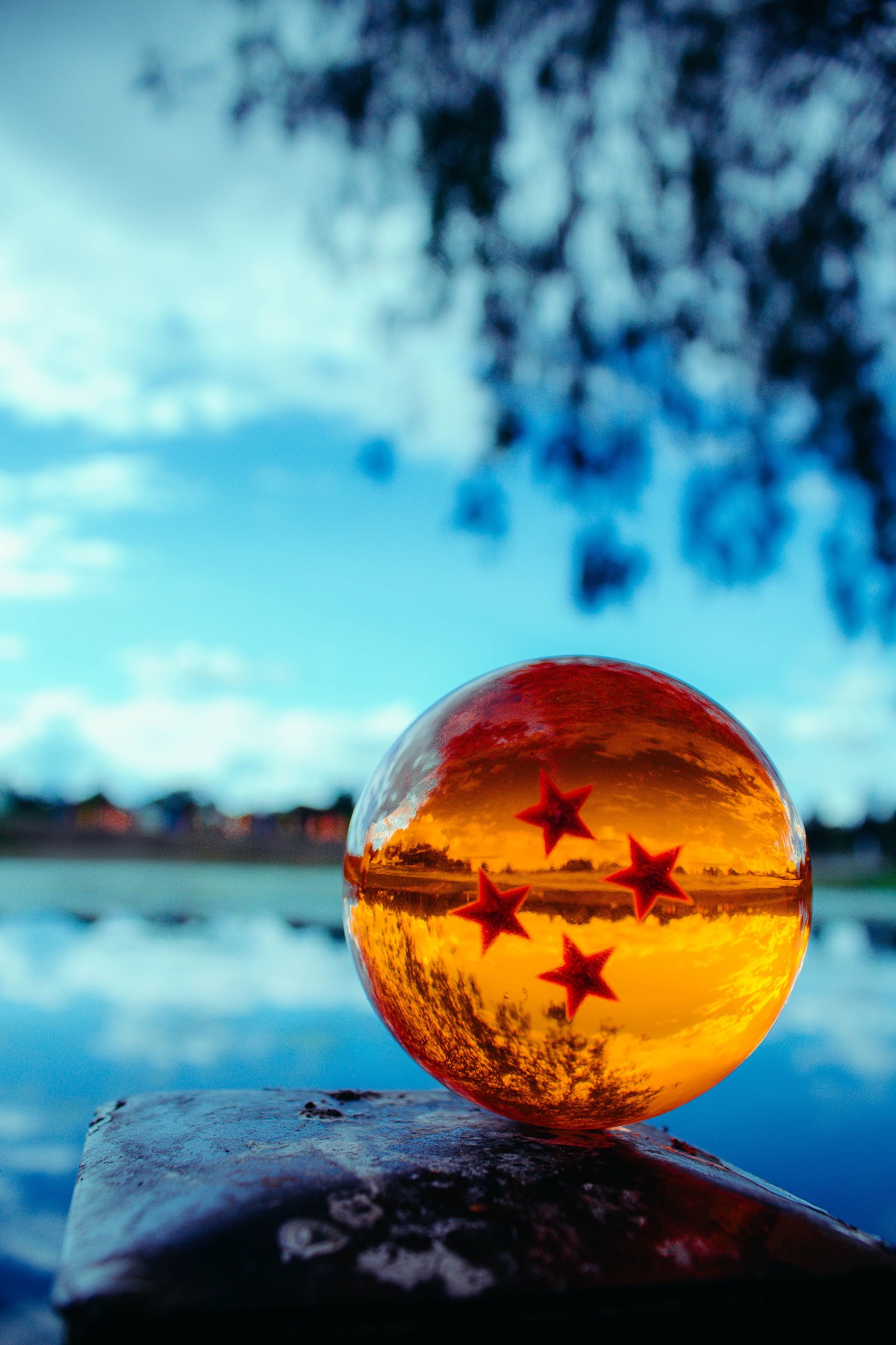 There is a glass ball with stars on it sitting on a rock (dragon ball z, star)