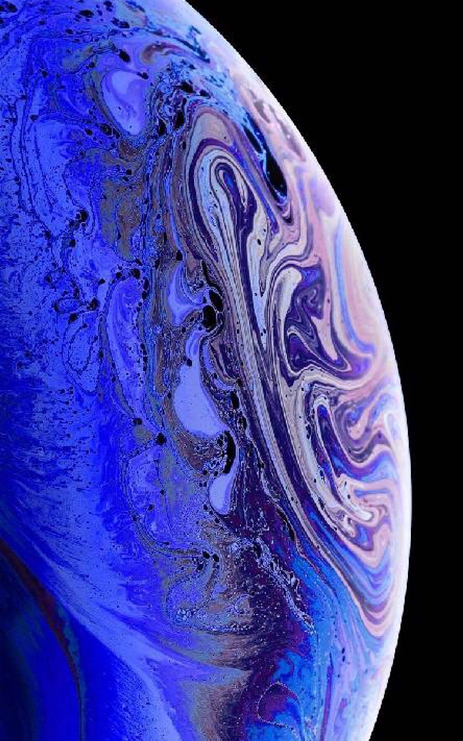 A close up of a blue and purple marbled surface on a black background (original, iphone, apple)