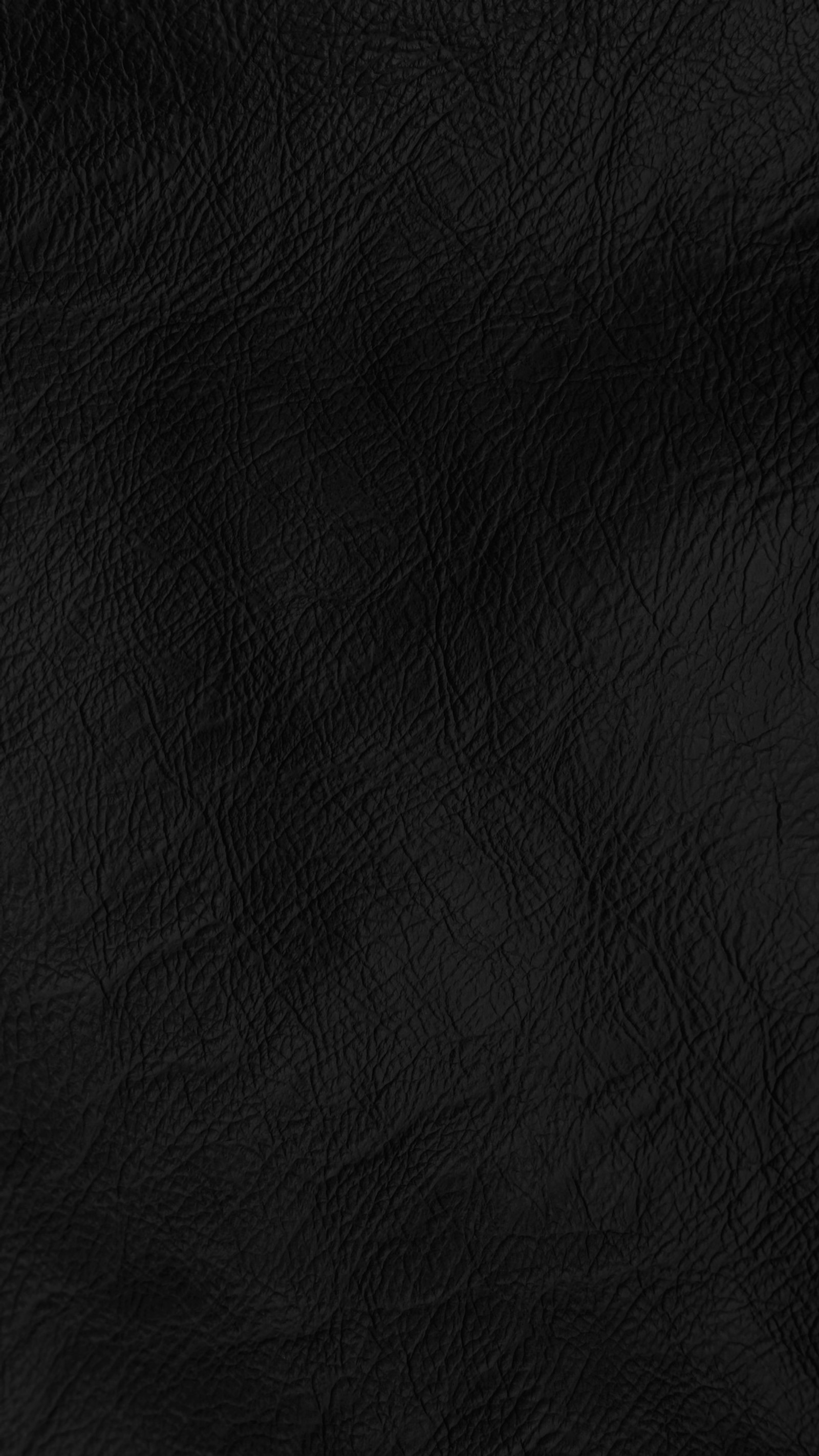 A close up of a black leather background with a very smooth surface (abstract, black, fabric, leather)