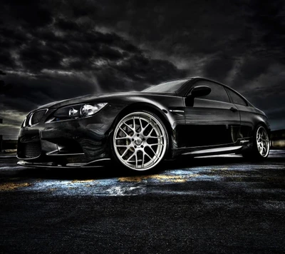 Sleek Black BMW M3 with Stylish Alloy Wheels Against a Dramatic Sky