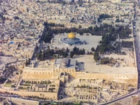 Vue aérienne de la mosquée Al-Aqsa et du paysage environnant à Jérusalem, mettant en valeur l'importance historique et culturelle du site en Palestine.