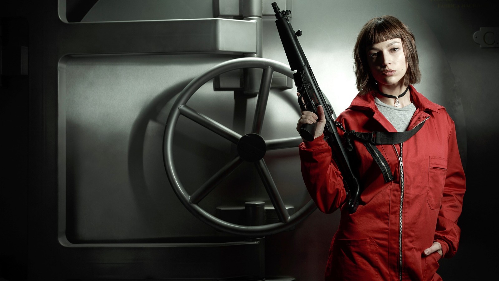 Arafed woman in red jacket holding a gun in front of a large metal door (úrsula corberó, tokyo, money heist, tv series, movies)