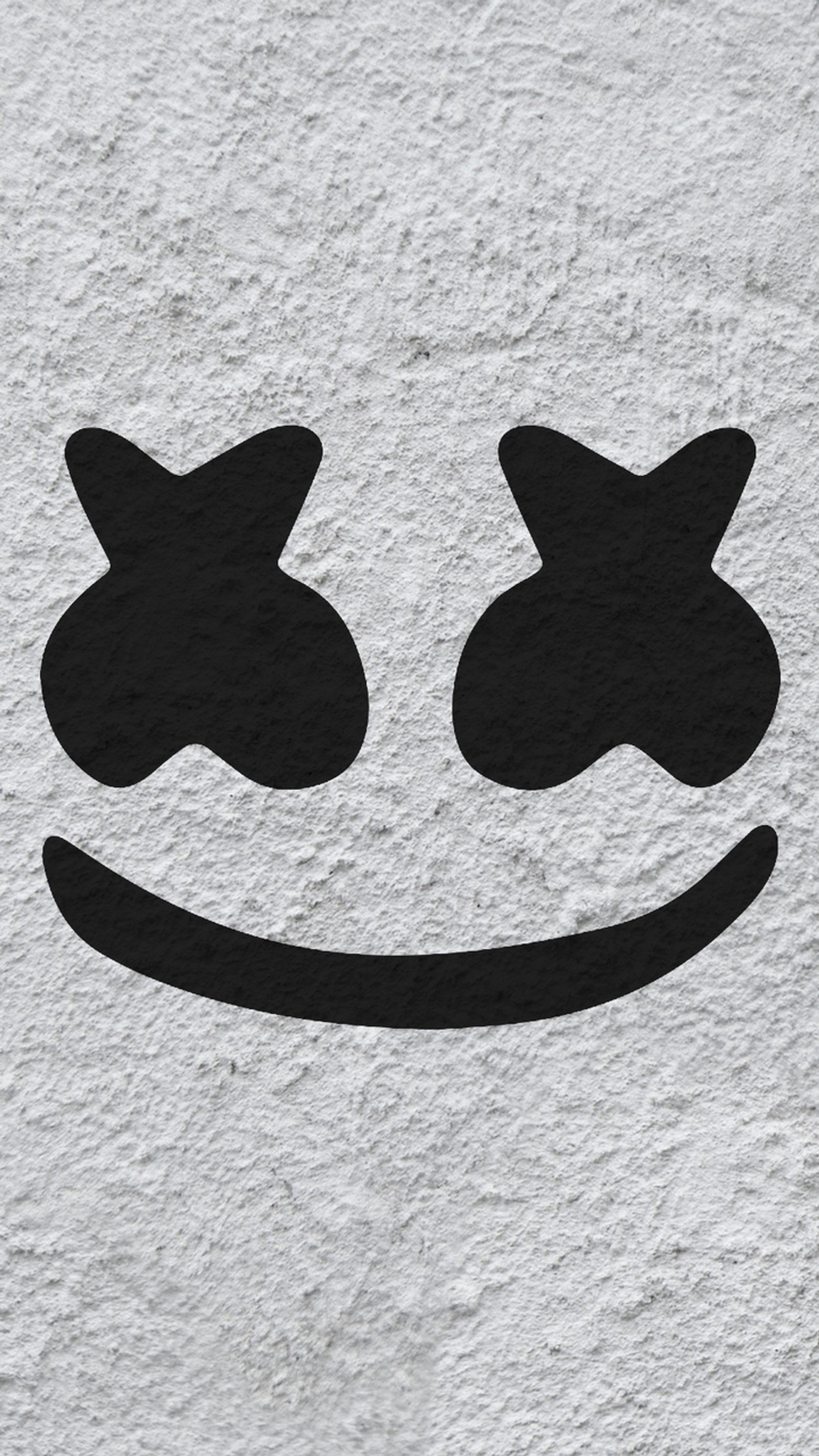 Eine nahaufnahme eines auf einer wand gezeichneten smiley-gesichts (logo, marshmello)