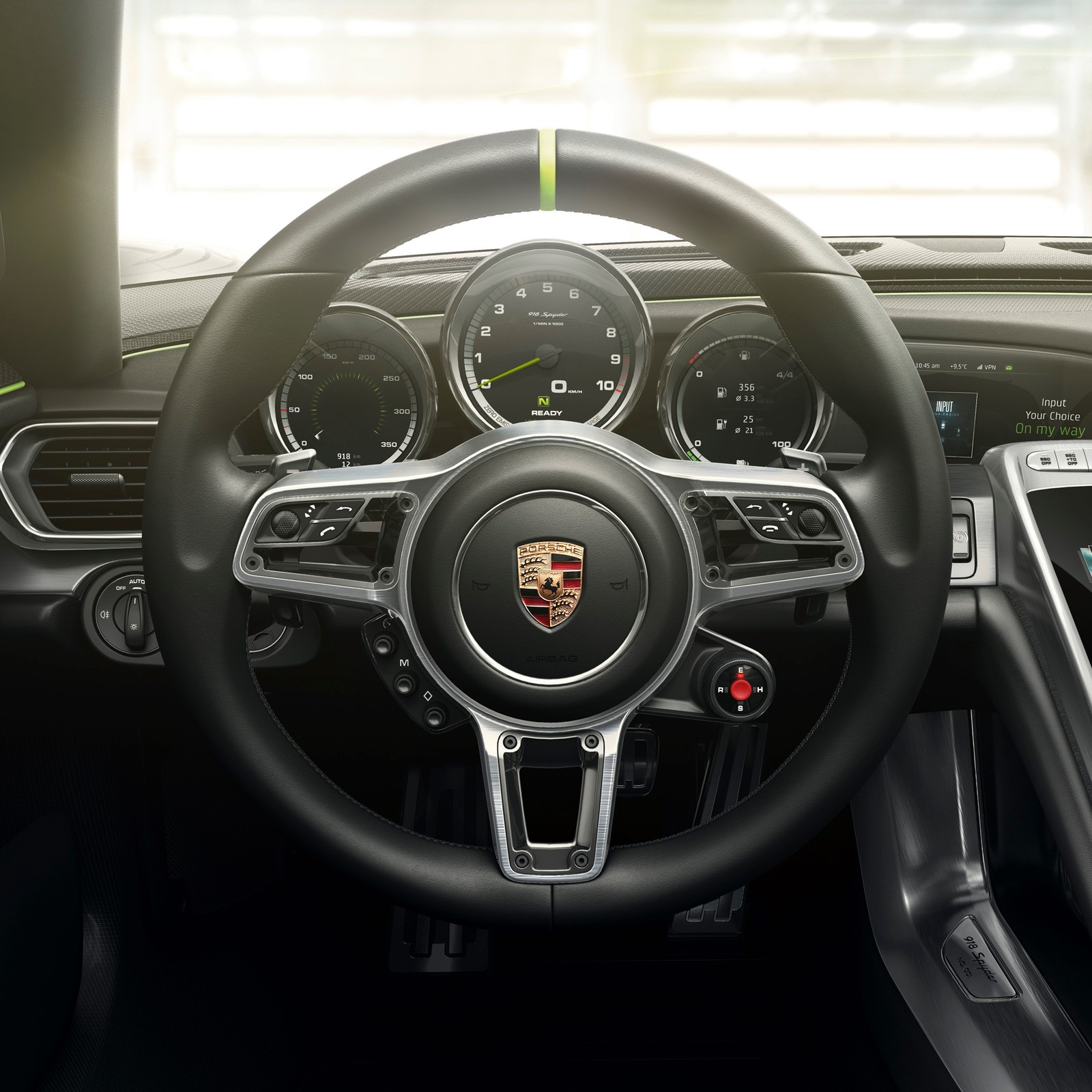 A close up of a steering wheel and dashboard of a car (918, emblem, hybrid, porsche, sports car)